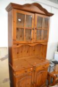 Pine dresser with glazed door above, drawers and cupboard below approx 88 cm wide