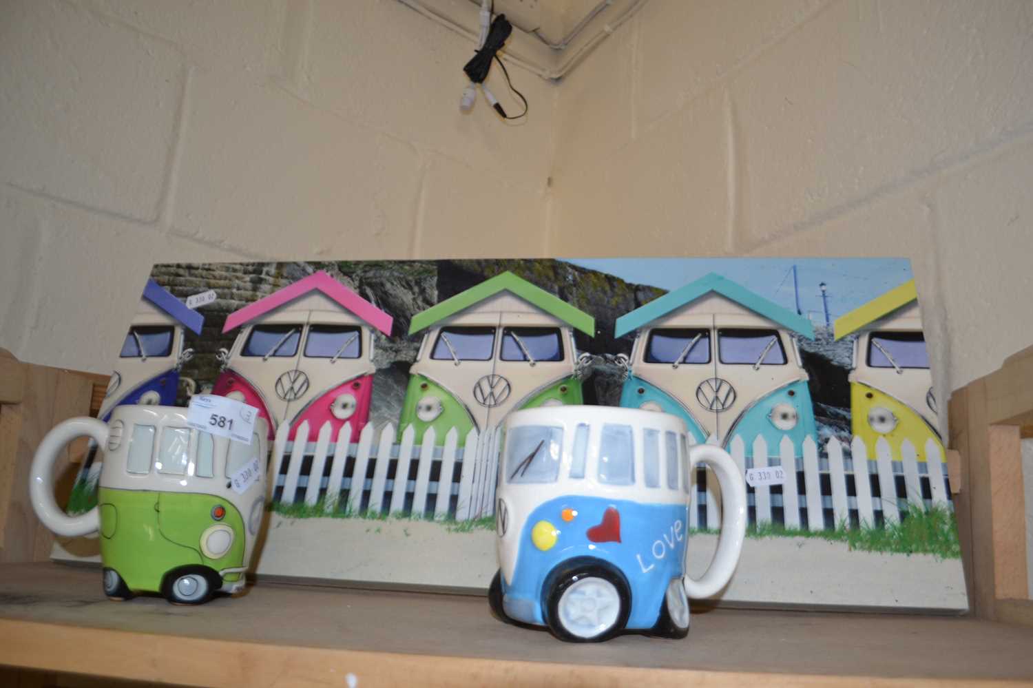 Two novelty VW campervan mugs and a similar picture