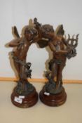 A pair of bronzed finish Spelter models of cherubs