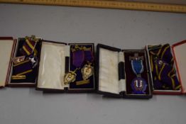 Collection of Manchester Unity Oddfellows badges and pendants to include silver gilt editions