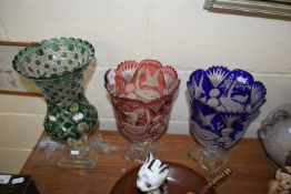 Group of three 20th Century bohemian coloured and clear cut glass vases