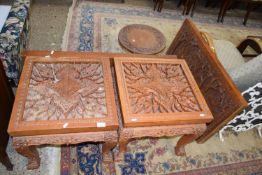 A suite of Far Eastern carved hardwood items comprising a pair of square topped lamp tables, a