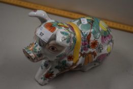 A Chinese pottery pig with Canton style decoration