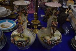 Pair of figural and floral encrusted vases of continental manufacture