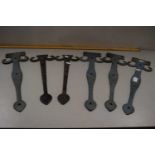 Three pairs of decorative iron door brackets