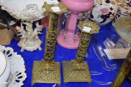 Pair of brass adjustable candlesticks with floral cherub and pierced decoration