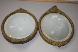 Pair of oval bevelled wall mirrors in gilt effect frames, 30cm high