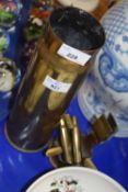 Two pieces of trench art including a shell case dated 1917 and a ashtray with matchbox holder and