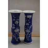 A pair of Chinese Gu vases decorated with prunus blossom, one with chip to top rim, 29cm high