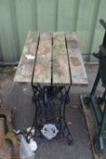 Garden table with Singer sewing machine base