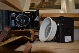 Boxed Brownie camera together with a Cherry toothpaste dish and another camera