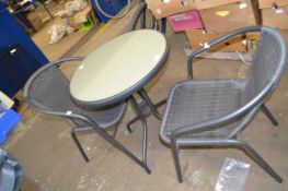 Round garden table with glazed top and a pair of matching dining chairs
