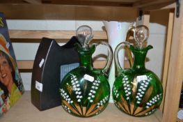 A pair of green glass decorated Lily-of-the-Valley decanters together with a pearlescent glass