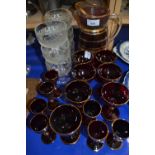 Quantity of red and gilt drinking glasses together with a similar jug and a set of six mid 20th