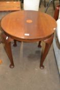 A round side table on cabriole legs