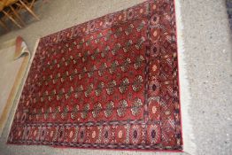 20th Century Middle Eastern wool floor rug with geometric design on a red background, 150 x 200 cm