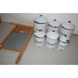 Six French enamel kitchen storage jars and a small wooden framed washboard