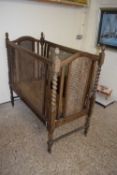 Early 20th Century oak framed and cane finish cot
