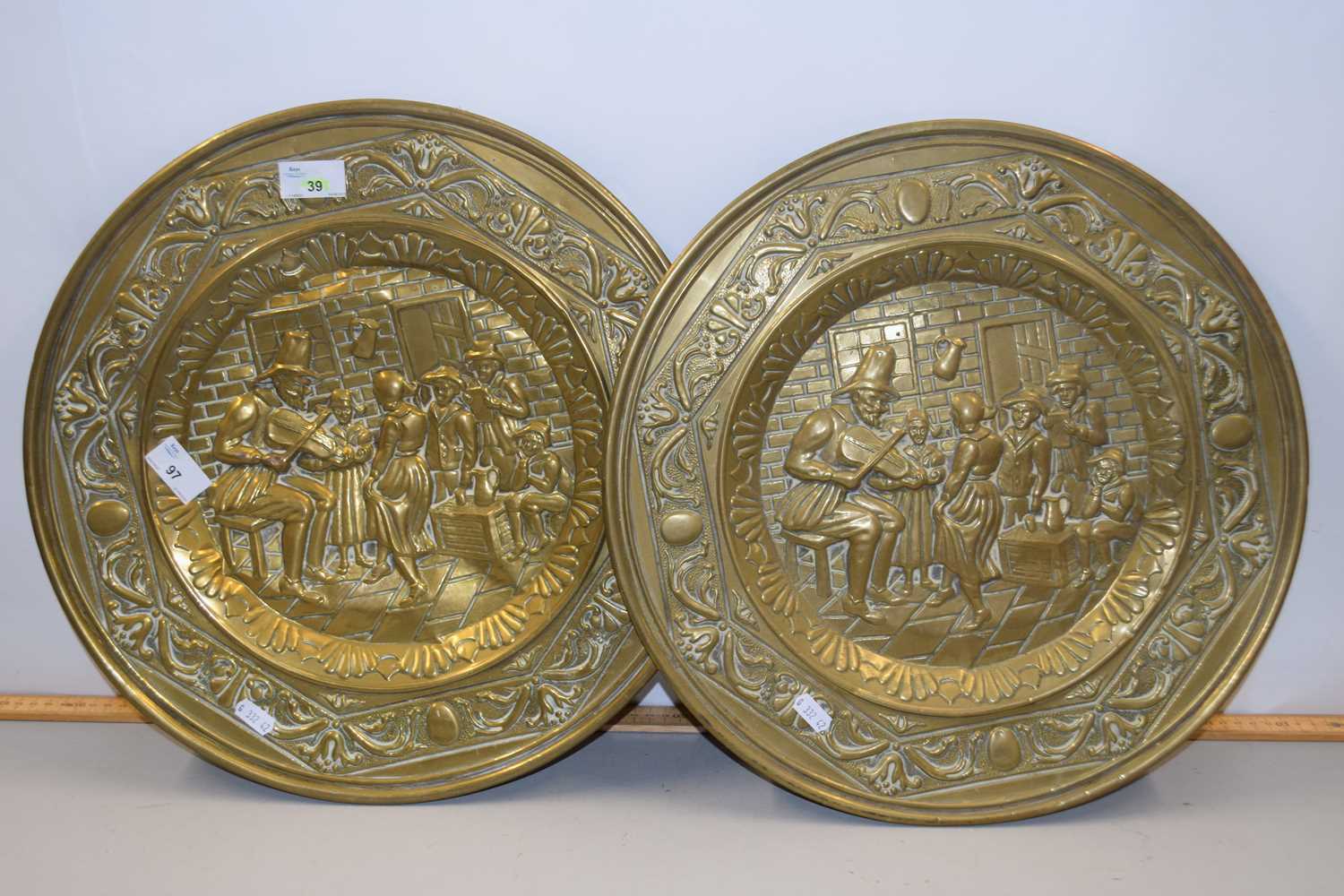 A pair of pressed brass wall plaques