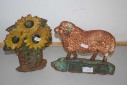 Cast iron door stop formed as a sheep and another formed as flowers