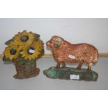 Cast iron door stop formed as a sheep and another formed as flowers