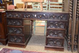 Late Victorian oak twin pedestal desk with carved decoration, 118cm wide
