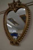 A heart shaped wall mirror