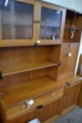 Mid 20th Century teak cabinet with cupboards and shelves above, drawer and cupboards below