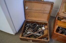 Wooden box of assorted spanners and other components