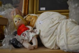 Three dolls, one in swaddling