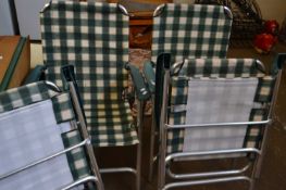 Four green and cream checked folding garden chairs