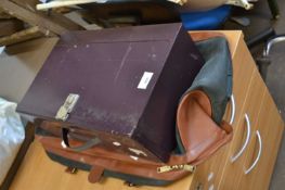Metal storage box and a green and tan holdall (2)