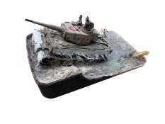 A painted German Tiger tank model on resin-based diorama.