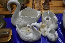 Collection of various swan shaped vases and planters