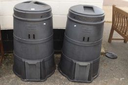 A pair of black plastic compost bins