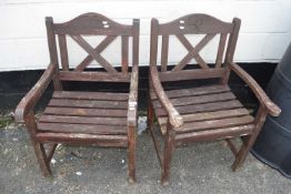 A near pair of teak garden chairs