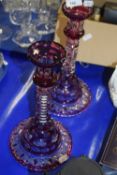 Pair of clear and overlaid glass candlesticks
