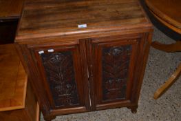 Late Victorian two door side cabinet with carved decoration, 65cm wide