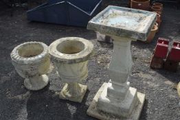 Reconstituted stone bird bath on pedestal and two reconstituted stone urns