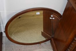 Edwardian oval bevelled wall mirror in mahogany frame