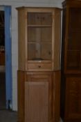 Composite two piece pine corner cabinet, top door detached