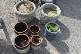A pair of reconstituted stone garden planters and a quantity of other pots