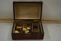 Inlaid box containing brass napkin rings and other items