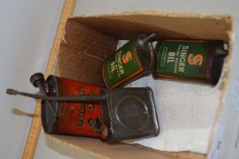 A collection of vintage oil cans to include Singer