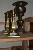 A pair of brass candlesticks and a brass dish on stand