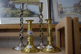 Pair of brass candlesticks and a pair of white metal candlesticks