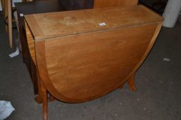 An oval drop leaf dining table