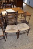 A pair of rush seat and ladder back side chairs