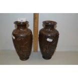 A pair of small Japanese bronzed metal vases decorated with herons