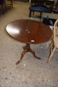 Mahogany circular topped supper table raised on a turned column with a tripod base